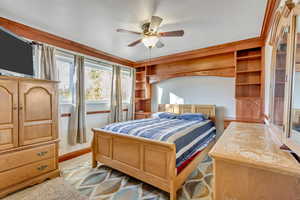 Bedroom featuring light carpet and ceiling fan