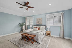 Bedroom featuring lofted ceiling, light carpet, and ceiling fan