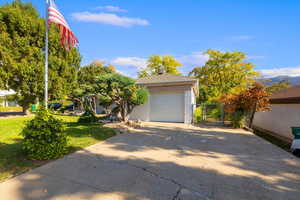 View of front of property with a garage and a front lawn