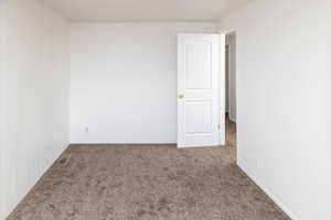 Bedroom with carpet and wooden walls