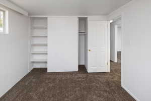 Bedroom with dark colored carpet