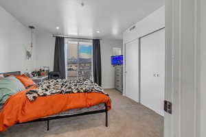 Bedroom featuring light colored carpet