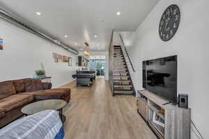 Living room featuring light wood-type flooring and billiards