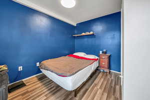 Bedroom with dark wood-type flooring