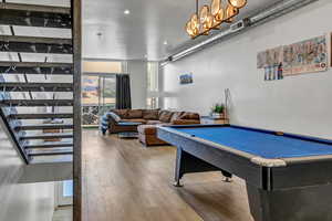 Recreation room with pool table and wood-type flooring