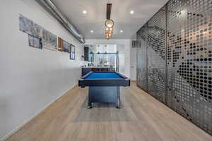 Playroom featuring billiards and light hardwood / wood-style flooring