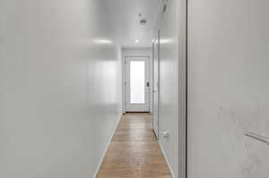 Hallway featuring light hardwood / wood-style flooring