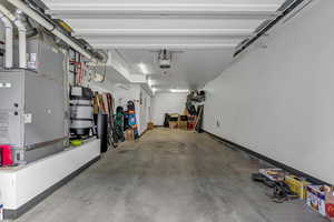 Garage featuring a garage door opener and heating unit