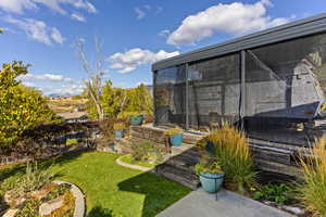 View of back yard landscaping/garden and additional parking.