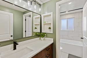 Newly renovated main full bath with oversized soaking tub and custom niches for additional storage. Sleek quartz countertops and matte black finishes.