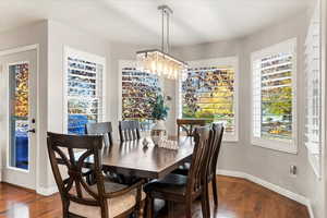 Dining room with bay window overlooking  the park-like backyard