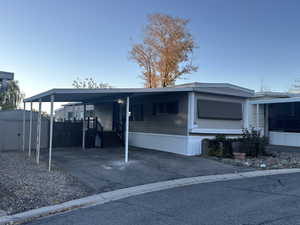 Exterior space featuring a shed and a carport