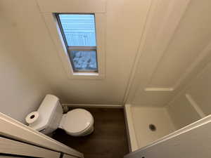 Bathroom featuring hardwood / wood-style flooring and toilet