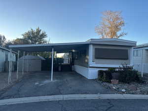 Exterior space with a shed and a carport