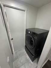 Laundry area featuring washer / clothes dryer and ornamental molding