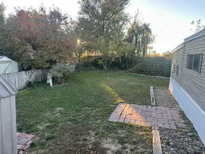 View of yard with a storage shed