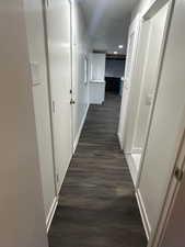 Hallway with dark wood-type flooring