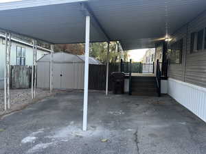 View of patio / terrace featuring a storage unit