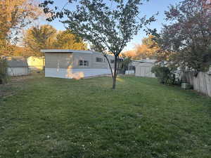 View of yard featuring central AC and a shed