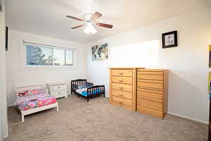 Bedroom with ceiling fan and carpet floors