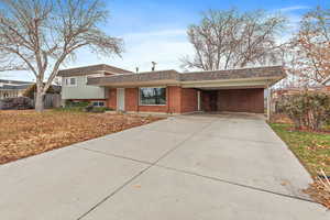 Split level home featuring a carport