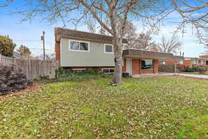 Rear view of property featuring a yard