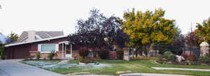 View of front of property with a garage and a front yard