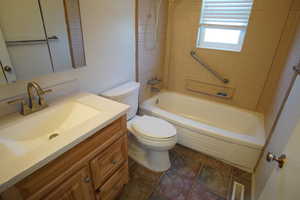 Full bathroom featuring vanity, toilet, and tiled shower / bath