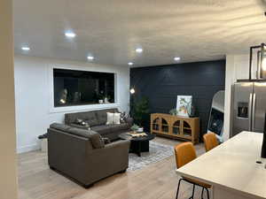 Living Room with Hardwood Flooring and Decorative Wall