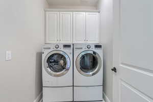 Laundry area with cabinets and washer and dryer