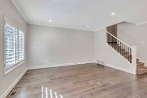 Front room with hardwood flooring and ornamental molding