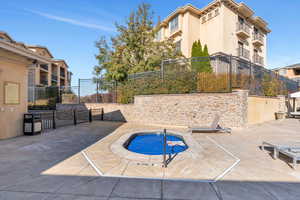 View of swimming pool with a patio area and a community hot tub