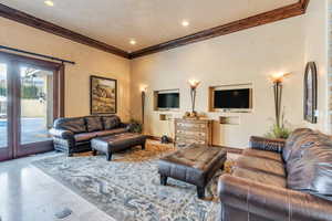 Tiled living room featuring crown molding