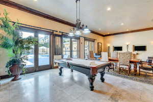 Recreation room featuring french doors, pool table, and crown molding