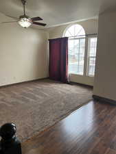 Carpeted spare room featuring ceiling fan