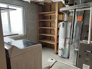 Utility room with heating unit, washer / dryer, and water heater