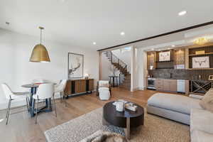 Living room featuring hardwood / wood-style floors, beverage cooler, and wet bar