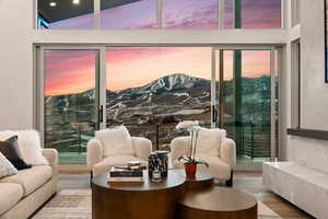 Interior space featuring hardwood / wood-style flooring, a mountain view, and high vaulted ceiling