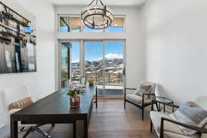 Dining area with hardwood / wood-style flooring, a chandelier, and a mountain view