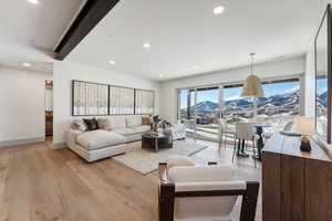 Living room with light wood-type flooring and a mountain view