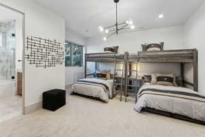 Bedroom with a chandelier and connected bathroom