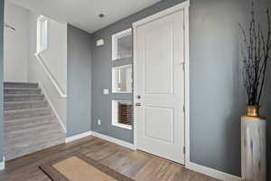 Foyer entrance with hardwood / wood-style flooring