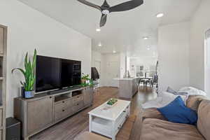 Living room featuring ceiling fan, sink, and dark hardwood / wood-style floors