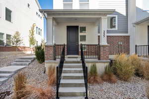 Entrance to property featuring covered porch