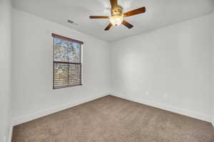 Unfurnished room with ceiling fan and carpet floors