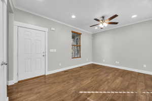 Entrance foyer with crown molding, hardwood / wood-style floors, and ceiling fan