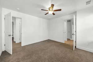 Unfurnished bedroom with light colored carpet and ceiling fan