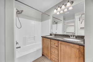 Bathroom with tile patterned floors, vanity, and shower / bathtub combination