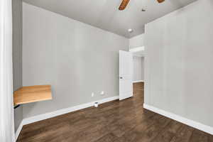 Unfurnished room with dark hardwood / wood-style flooring and ceiling fan