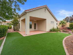 Rear view of house with a patio area, a lawn, and ceiling fan